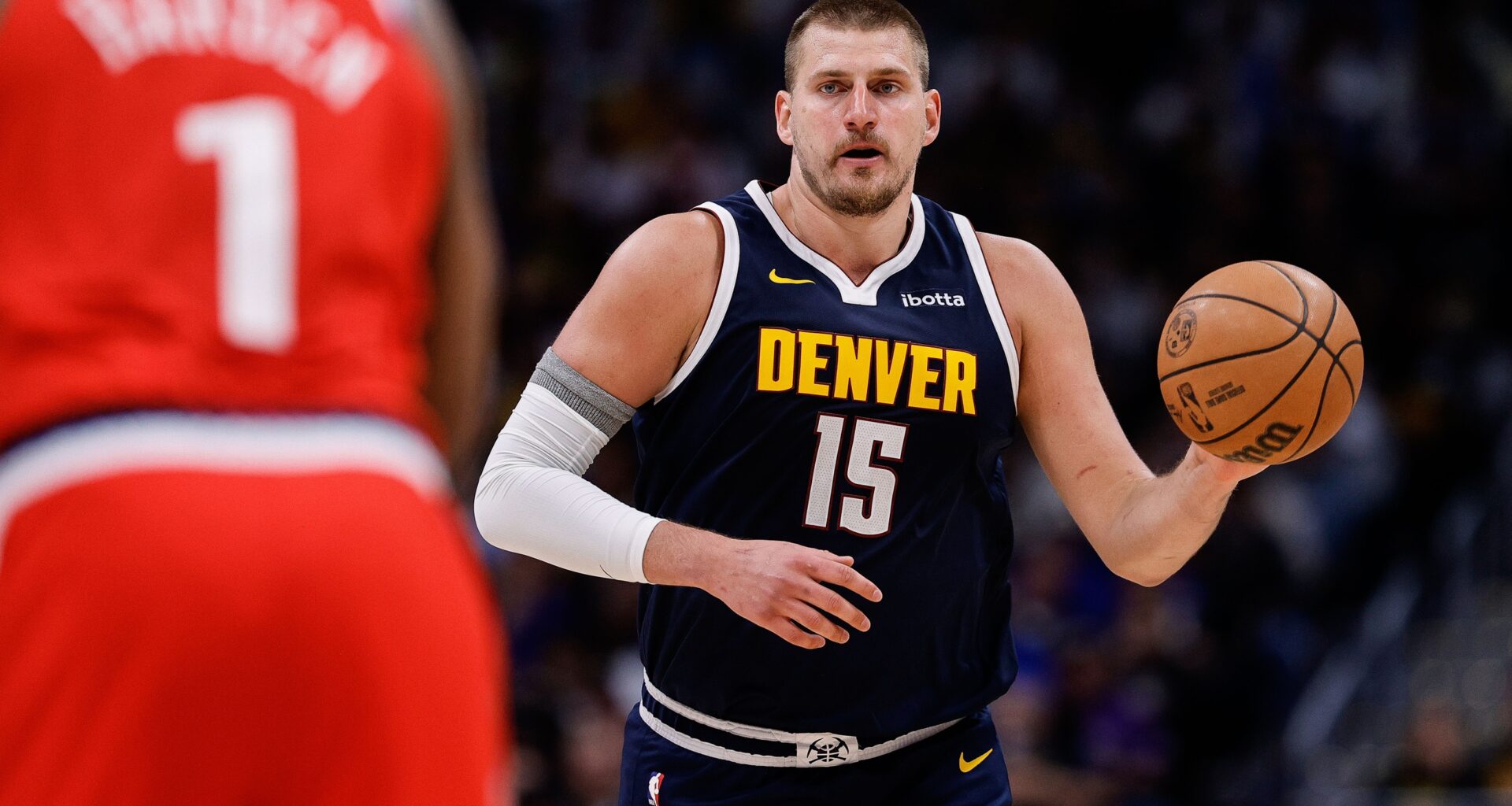 Apr 21, 2025; Denver, Colorado, USA; Denver Nuggets center Nikola Jokic (15) dribbles the ball up court against Los Angeles Clippers guard James Harden (1) in the third quarter during game two of first round for the 2025 NBA Playoffs at Ball Arena. Mandatory Credit: Isaiah J. Downing-Imagn Images