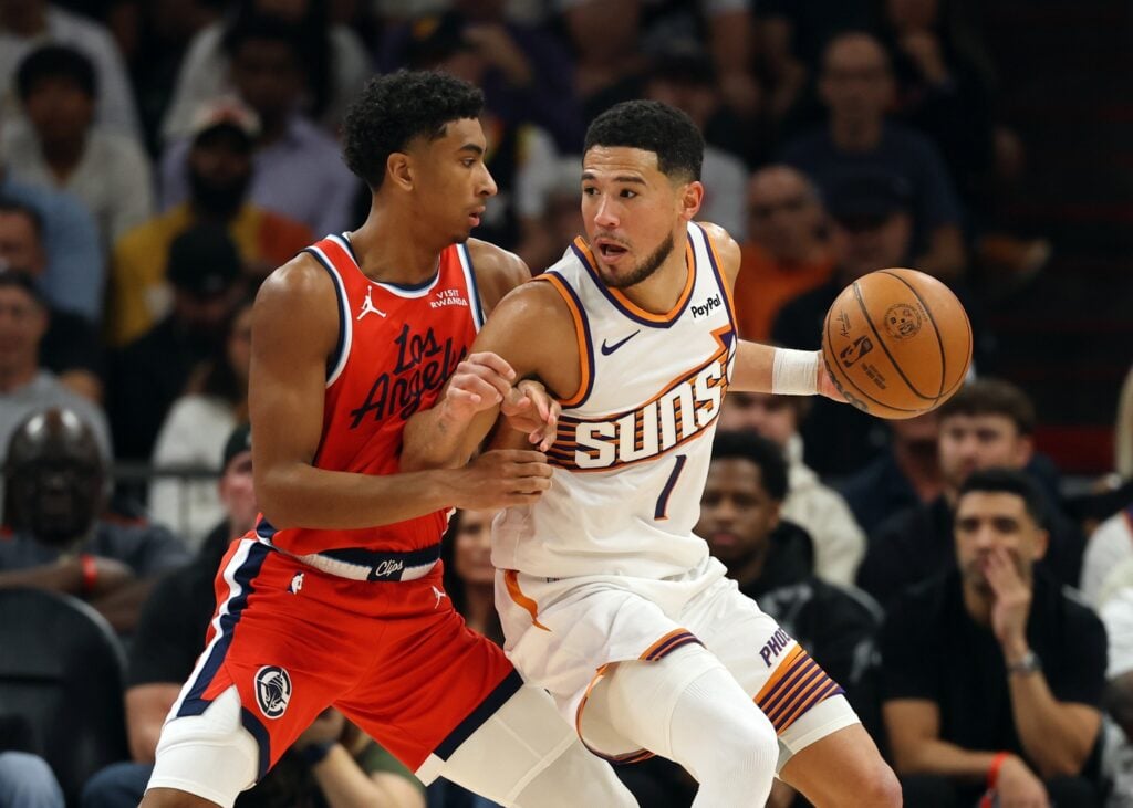 Phoenix Suns guard Devin Booker (1) against Los Angeles Clippers guard Cam Christie in the first half at the Mortgage Matchup Center.