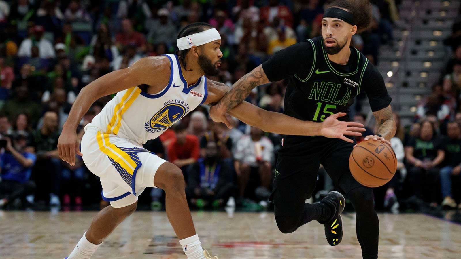 Golden State Warriors guard Moses Moody (4) guards against New Orleans Pelicans guard Jose Alvarado (15) during the first half at Smoothie King Center.