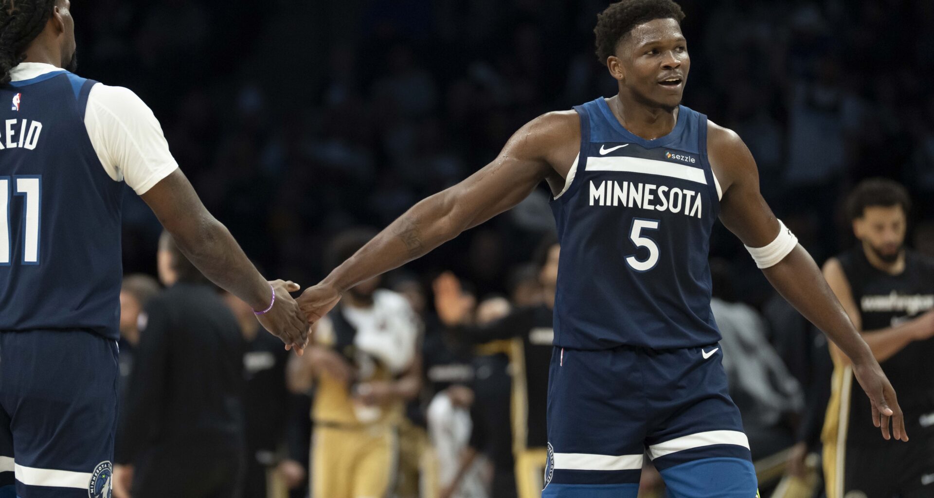 Timberwolves star Anthony Edwards high five Naz Reid during the 2025-26 NBA season.