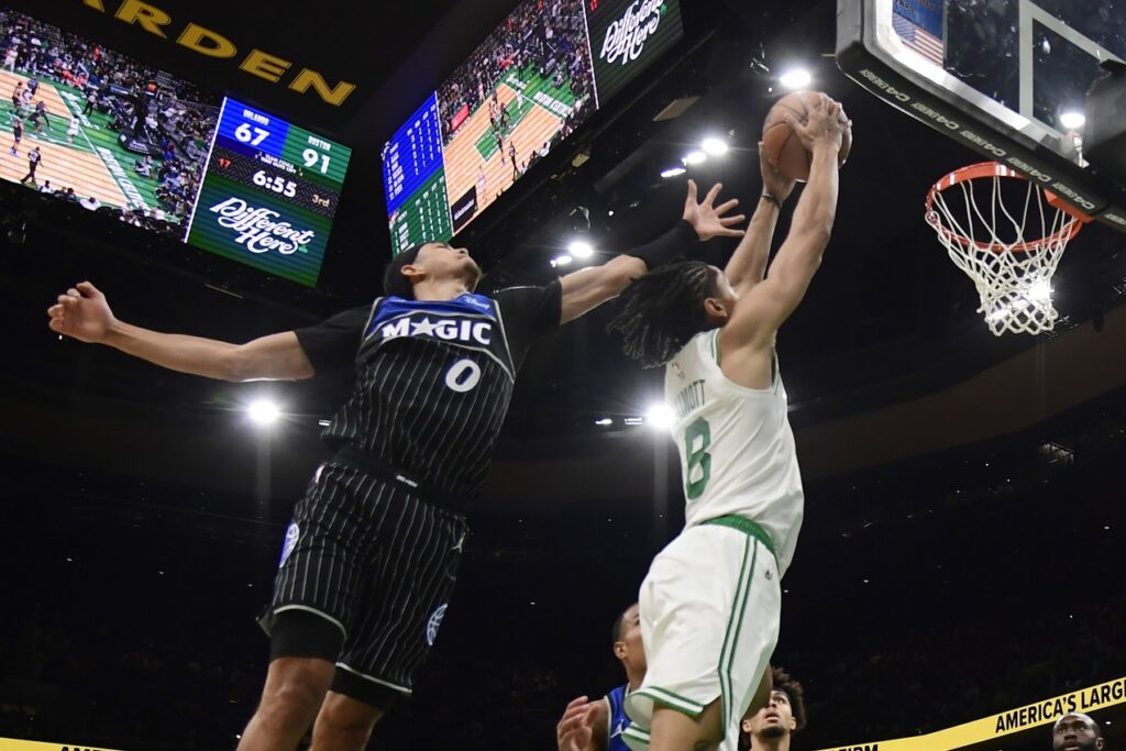 Boston Celtics forward Josh Minott (8) dunks the ball while Orlando Magic guard Anthony Black (0) defends during the second half at TD Garden.