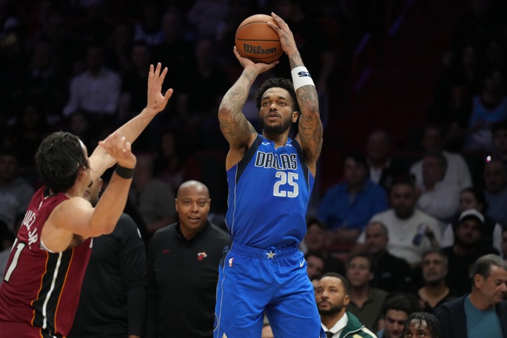 Dallas Mavericks forward P.J. Washington (25) takes a shot over Miami Heat forward Jaime Jaquez Jr. (11) during the second half at Kaseya Center.