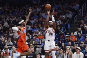 Nov 28, 2025; Oklahoma City, Oklahoma, USA; Phoenix Suns guard Jordan Goodwin (23) shoots a three point basket as Oklahoma City Thunder guard Shai Gilgeous-Alexander (2) defends during the second quarter at Paycom Center. Mandatory Credit: Alonzo Adams-Imagn Images