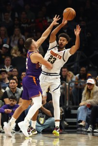 Nov 29, 2025; Phoenix, Arizona, USA; Denver Nuggets forward Cameron Johnson (23) passes the ball against Phoenix Suns guard Grayson Allen (8) in the first half at the Mortgage Matchup Center. Mandatory Credit: Mark J. Rebilas-Imagn Images
