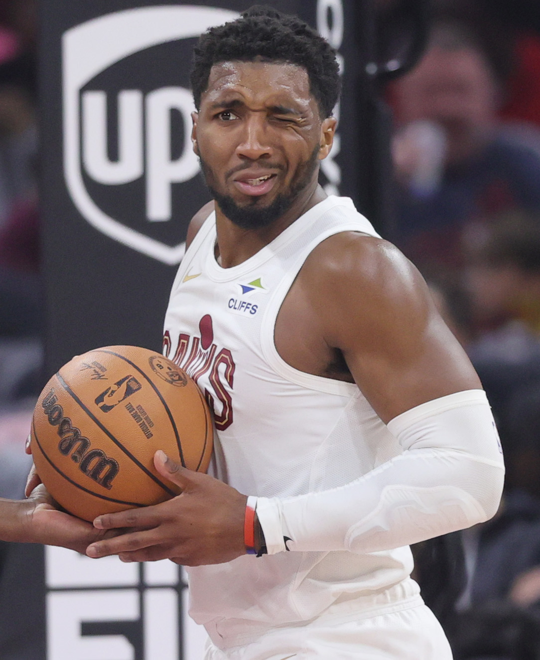 Cleveland Cavaliers guard Donovan Mitchell winces as he recovers from being poked in the eye in the first half at Rocket Arena. 
