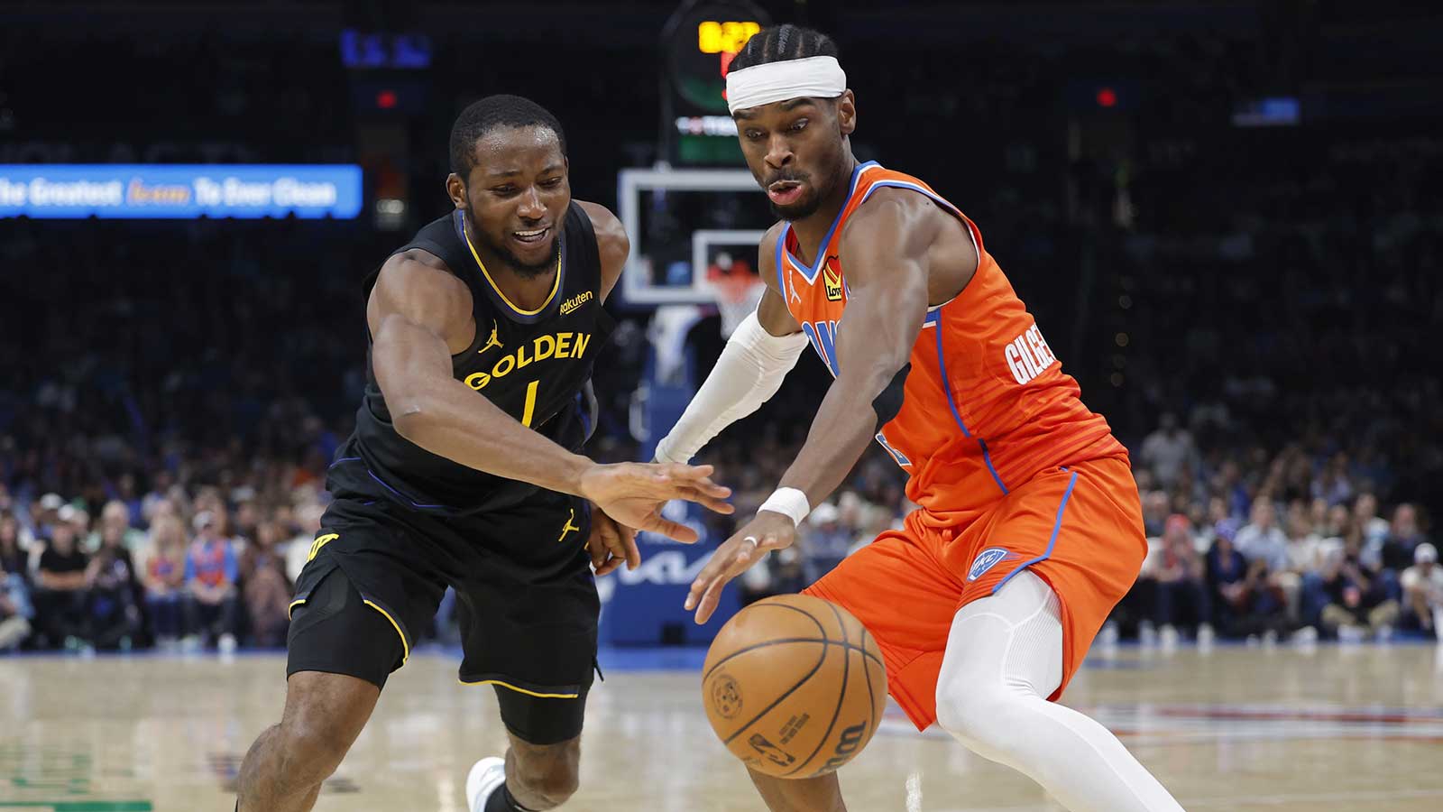 Warriors forward Jonathan Kuminga (1) and Oklahoma City Thunder guard Shai Gilgeous-Alexander (2) reach for a loose ball during the second half at Paycom Center
