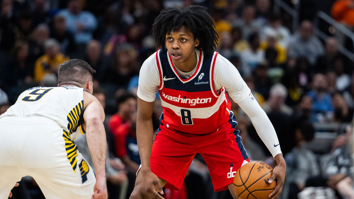 Washington Wizards guard Bub Carrington (8) dribbles the ball while Indiana Pacers guard T.J. McConnell (9) defends in the second half at Gainbridge Fieldhouse.
