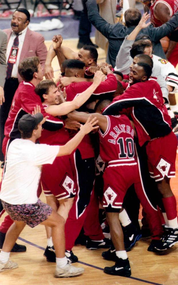 John Paxson is surrounded by Bulls teammates after sinking the game-winning shot in Game 6 of the NBA Finals against the Suns on June 20, 1993, in Phoenix. (Chicago Tribune file photo)