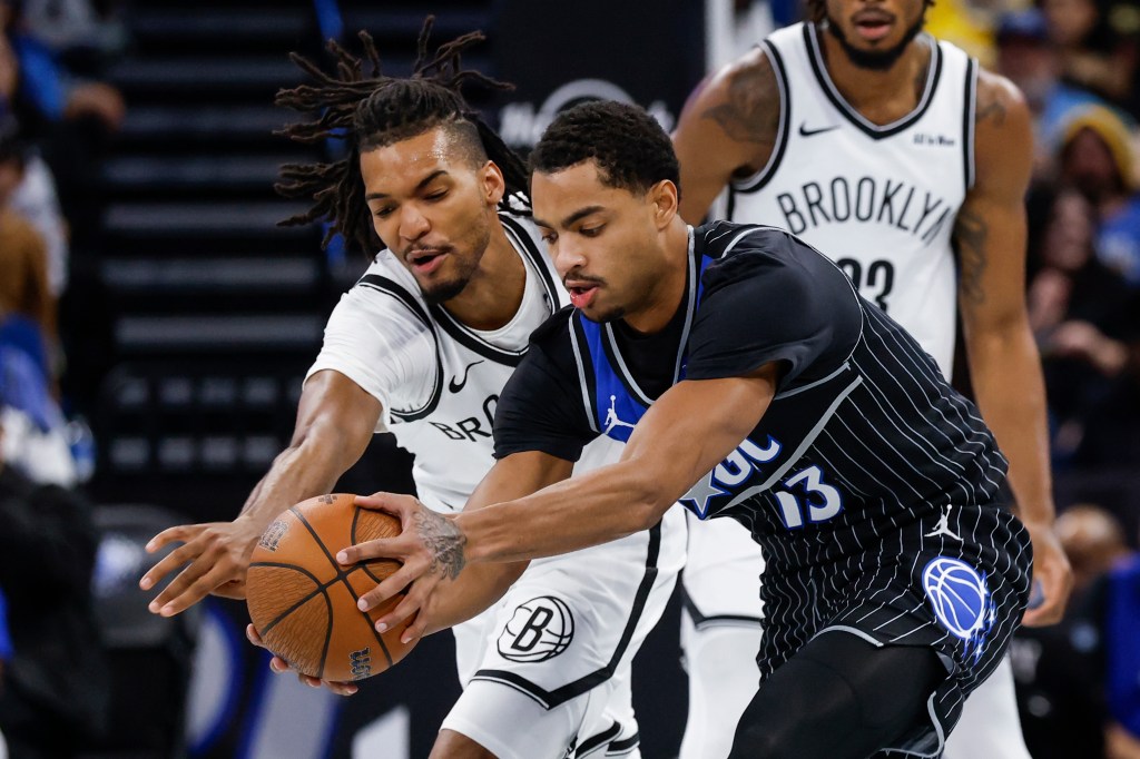 Ziaire Williams (left) battles Orlando guard Jeff Howard battle for a loose ball during the Nets' 105-98 road loss to the Magic on Nov. 14, 2025.