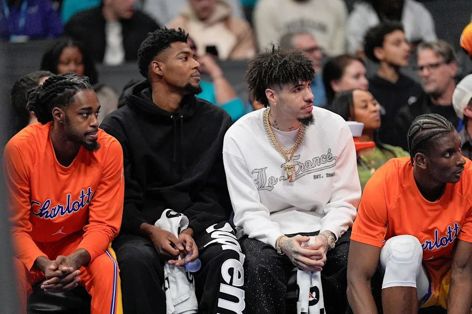Nov 15, 2025; Charlotte, North Carolina, USA; Charlotte Hornets forward Brandon Miller (24) and Charlotte Hornets guard LaMelo Ball (1) sit on the sideline during the first half against the Oklahoma City Thunder at Spectrum Center. Mandatory Credit: Jim Dedmon-Imagn Images