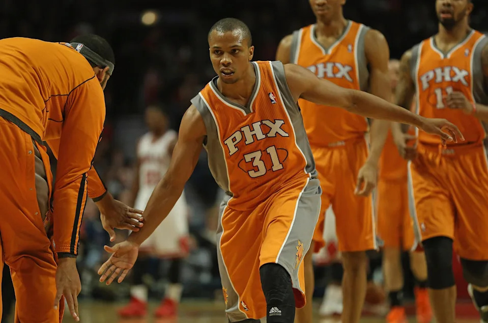 Sebastian Telfair #31 of the Phoenix Suns is congratulated by teammates as he leaves the floor during a time-out against the Chicago Bulls at the United Center on Jan. 12, 2013, in Chicago, Illinois.