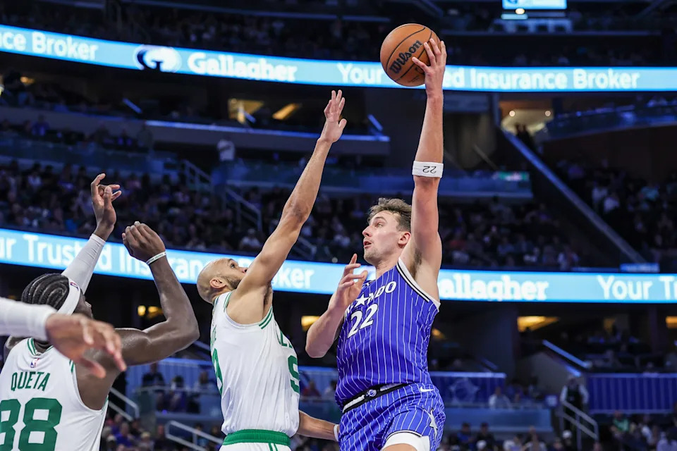 Nov 9, 2025; Orlando, Florida, USA; Orlando Magic forward Franz Wagner (22) shoots against Boston Celtics guard Derrick White (9) during the second half at Kia Center. Mandatory Credit: Mike Watters-Imagn Images