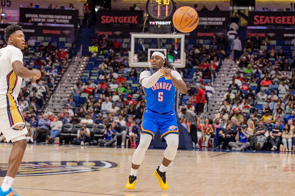 Nov 17, 2025; New Orleans, Louisiana, USA; Oklahoma City Thunder guard Luguentz Dort (5) passes against New Orleans Pelicans center Derik Queen (22) during the first half at Smoothie King Center. Mandatory Credit: Stephen Lew-Imagn Images