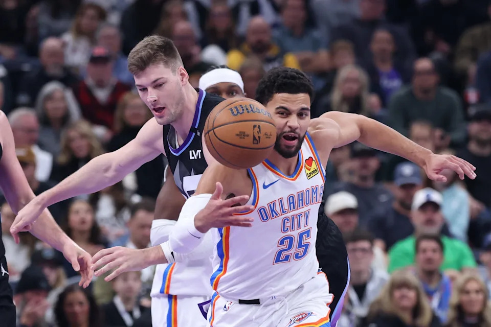 Nov 21, 2025; Salt Lake City, Utah, USA; Oklahoma City Thunder guard Ajay Mitchell (25) and Utah Jazz forward Kyle Filipowski (22) play for the ball during the first half at Delta Center. Mandatory Credit: Rob Gray-Imagn Images