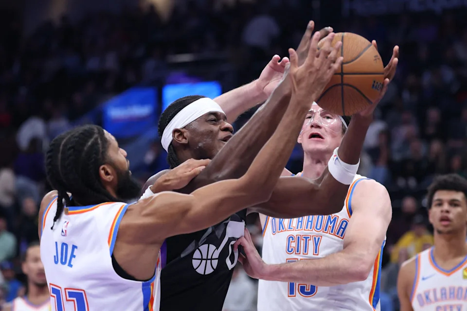 Nov 21, 2025; Salt Lake City, Utah, USA; Utah Jazz forward Taylor Hendricks (0) goes to the basket against Oklahoma City Thunder guard Isaiah Joe (11) and center Branden Carlson (15) during the second half at Delta Center. Mandatory Credit: Rob Gray-Imagn Images