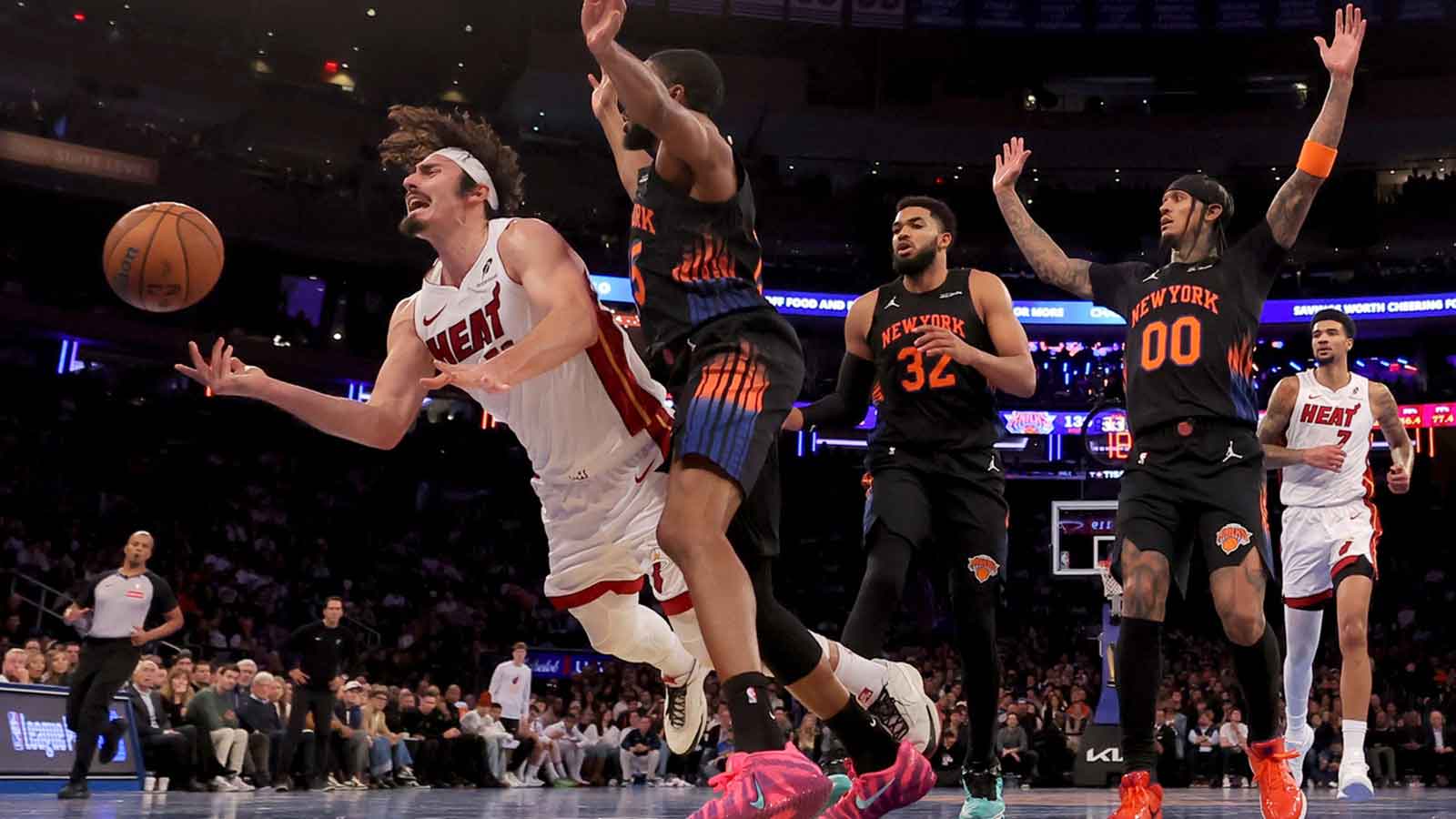 Miami Heat forward Jaime Jaquez Jr. (11) loses control of the ball as he drives to the basket against New York Knicks guard Mikal Bridges (25) and center Karl-Anthony Towns (32) and guard Jordan Clarkson (00) during the fourth quarter at Madison Square Garden.