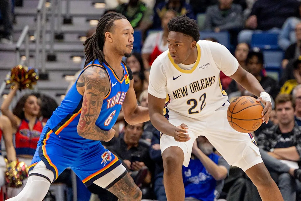 Nov 17, 2025; New Orleans, Louisiana, USA; New Orleans Pelicans center Derik Queen (22) dribbles against Oklahoma City Thunder forward Jaylin Williams (6) during the first half at Smoothie King Center. Mandatory Credit: Stephen Lew-Imagn Images