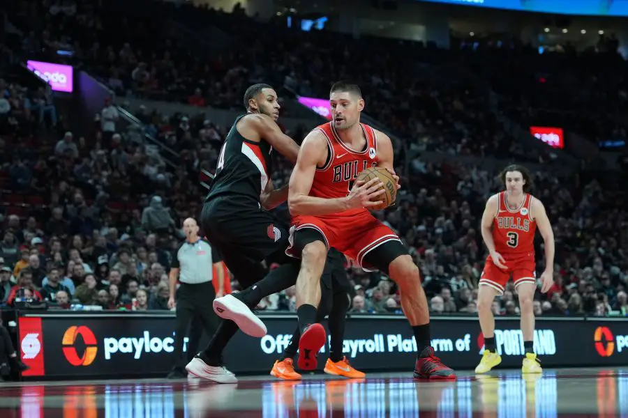 Nov 19, 2025; Portland, Oregon, USA; Chicago Bulls center Nikola Vucevic (9) attempts to score as Portland Trail Blazers forward Kris Murray (24) defends during the first half at Moda Center. Mandatory Credit: Soobum Im-Imagn Images