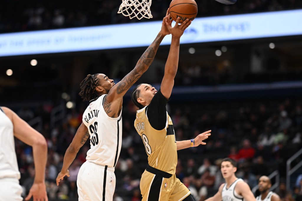 Brooklyn Nets center Nic Claxton (33) blocks a shot by Washington Wizards forward Kyshawn George (18).