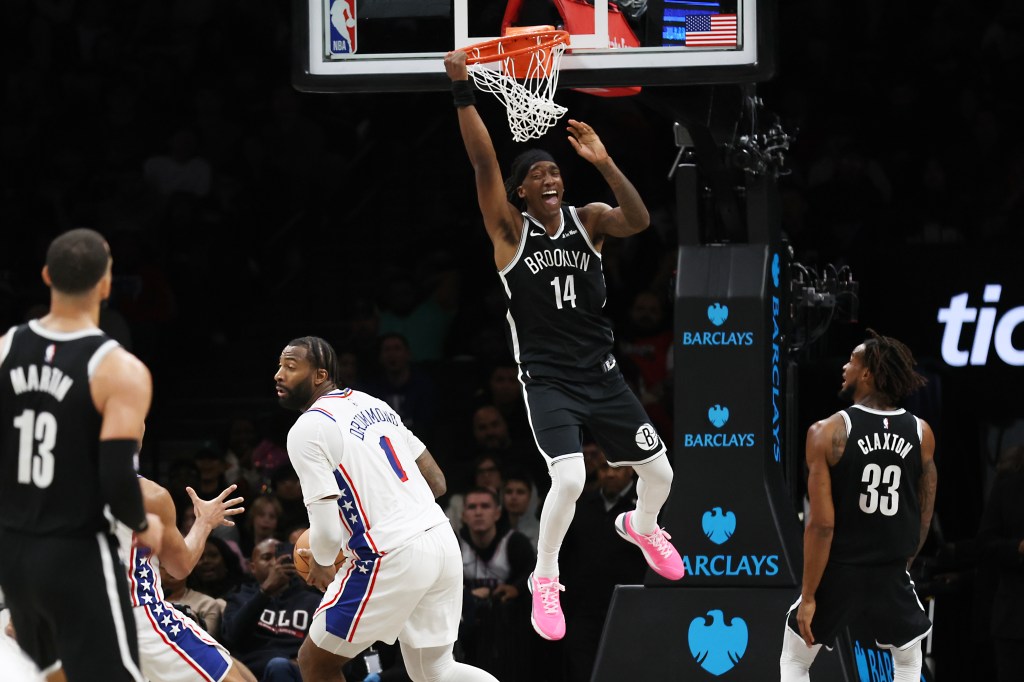 Brooklyn Nets guard Terance Mann (14) hangs on the rim after a missed dunk attempt during the second half of a game against the Philadelphia 76ers at Barclays Center in Brooklyn, N.Y. on Sunday, Nov. 2, 2025.