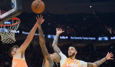 Milwaukee Bucks' Kyle Kuzma, center, shoots over Cleveland Cavaliers' Dean Wade, left, and Lonzo Ball (2) during the first half of an NBA basketball game in Cleveland, Monday, Nov. 17, 2025. (AP Photo/Phil Long)
