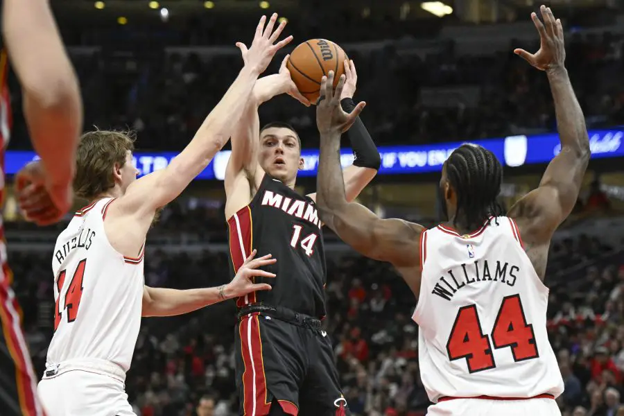 Feb 4, 2025; Chicago, Illinois, USA; Miami Heat guard Tyler Herro (14) passes the ball away from Chicago Bulls forward Matas Buzelis (14) and forward Patrick Williams (44) during the second half at United Center. Mandatory Credit: Matt Marton-Imagn Images