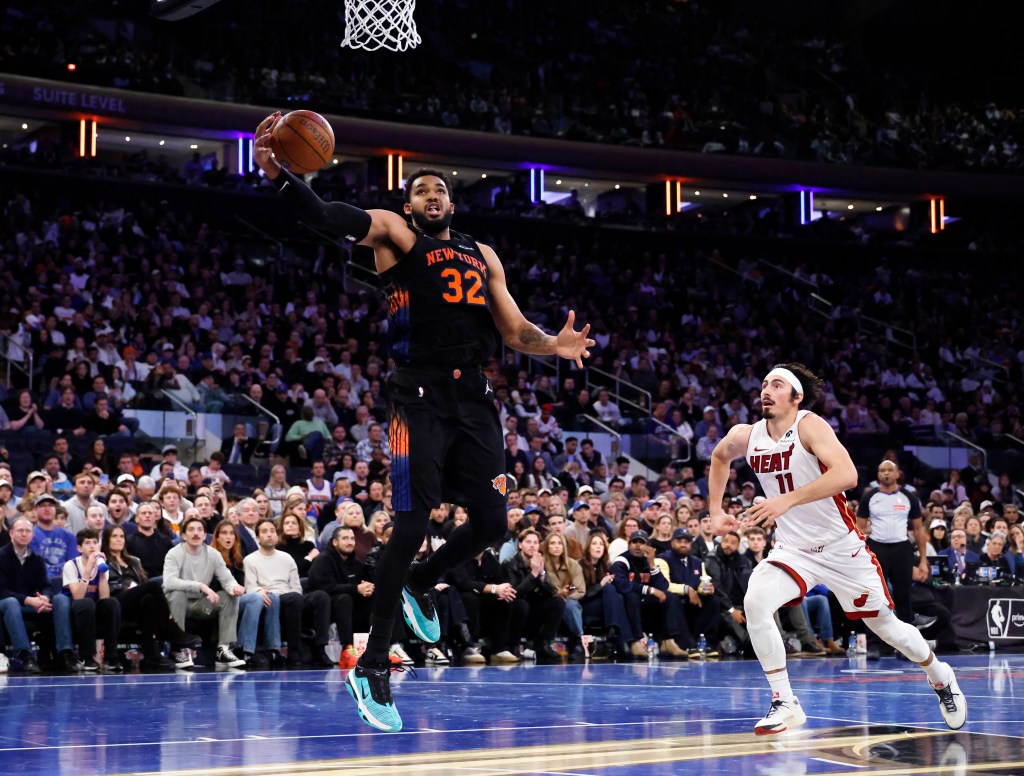 Knicks center Karl-Anthony Towns (C) grabs a rebound from Miami Heat forward Jaime Jaquez Jr. (R) on Nov. 14, 2025.