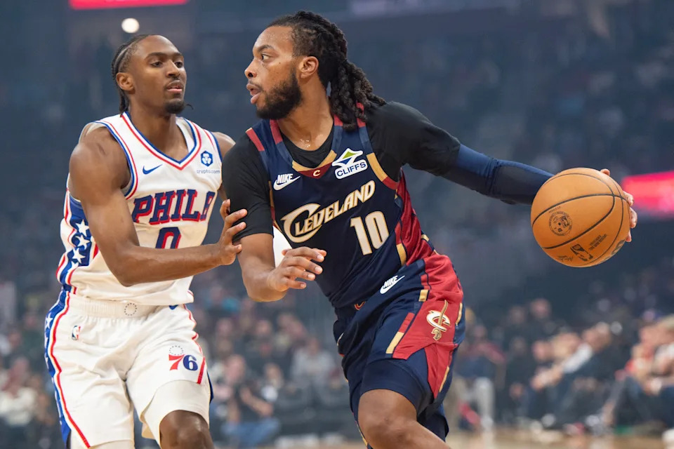 Philadelphia 76ers' Tyrese Maxey, left, defends against Cleveland Cavaliers' Darius Garland (10) during the first half of an NBA basketball game in Cleveland, Wednesday, Nov. 5, 2025. (AP Photo/Phil Long)
