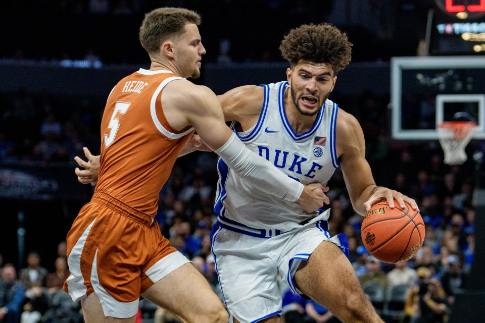 ameron Boozer #12 of the Duke Blue Devils drives against Camden Heide #5 of the Texas Longhorns 