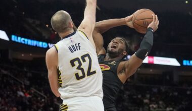Cleveland Cavaliers guard Donovan Mitchell, right, looks to shoot as Indiana Pacers center Jay Huff (32) defends in the second half of an NBA Cup basketball game Friday, Nov. 21, 2025, in Cleveland. (AP Photo/Sue Ogrocki)