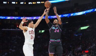 Miami Heat guard Norman Powell (24) aims a three-point shot as Cleveland Cavaliers guard Tyrese Proctor (24) defends during the first half of an NBA basketball game Wednesday, Nov. 12, 2025, in Miami. (AP Photo/Marta Lavandier)