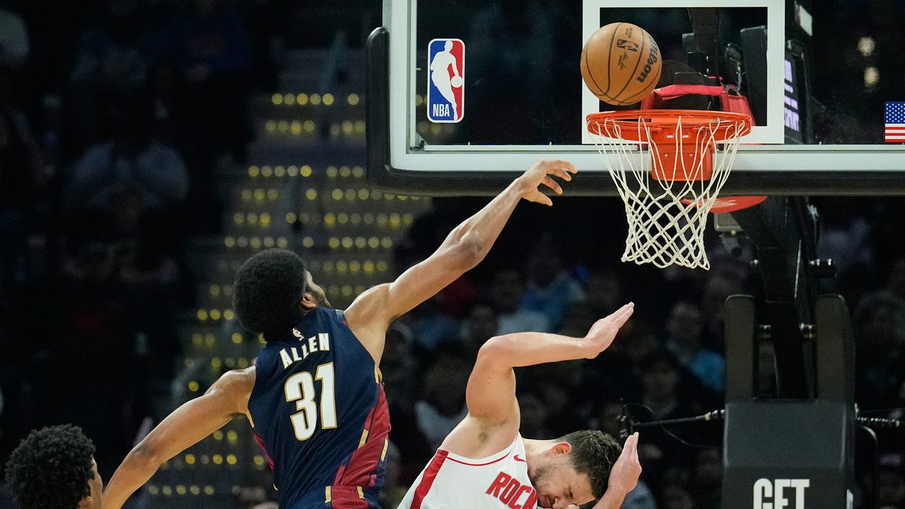 Cleveland Cavaliers center Jarrett Allen (31) is called for an offensive foul on Houston Rockets center Alperen Sengun (28) as he shoots in the first half of an NBA basketball game Wednesday, Nov. 19, 2025, in Cleveland. (AP Photo/Sue Ogrocki)