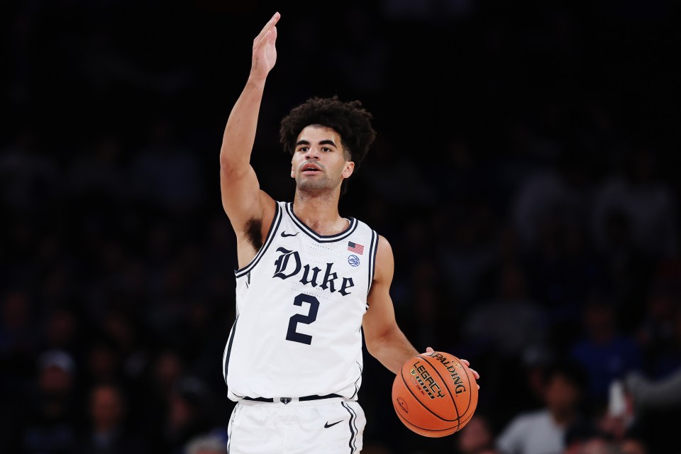 ayden Boozer #2 of the Duke Blue Devils dribbles during the first half against Kansas Jayhawks