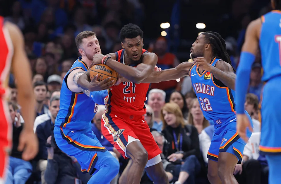 Nov 2, 2025; Oklahoma City, Oklahoma, USA; Oklahoma City Thunder center Isaiah Hartenstein (55), guard Cason Wallace (22), and New Orleans Pelicans center Yves Missi (21) fight for control of the ball during the second quarter at Paycom Center. Mandatory Credit: Alonzo Adams-Imagn Images