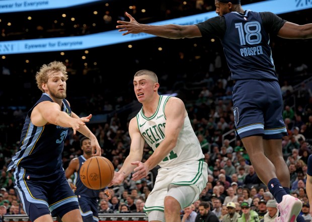 Payton Pritchard (11) of the Boston Celtics passes away from Jock Landale (31) and Olivier-Maxence Prosper (18) of the Memphis Grizzlies. (Photo By Matt Stone/Boston Herald)