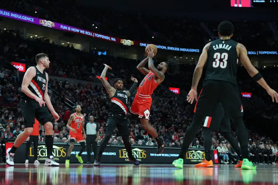 Nov 19, 2025; Portland, Oregon, USA; Chicago Bulls guard Coby White (0) is fouled by Portland Trail Blazers guard Caleb Love (2) while shooting during the first half at Moda Center. Mandatory Credit: Soobum Im-Imagn Images
