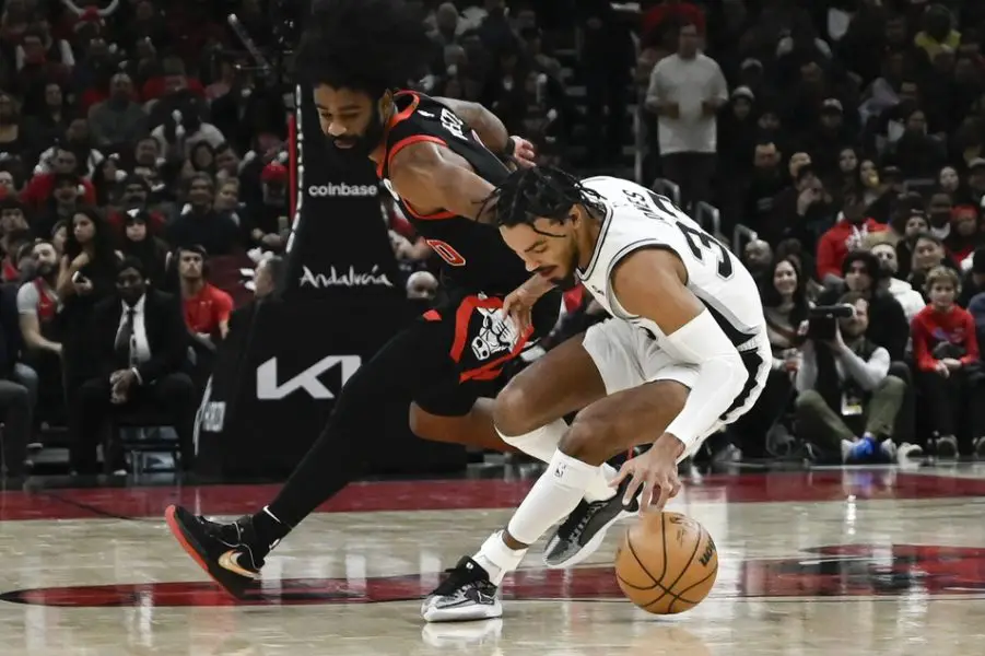 Dec 21, 2023; Chicago, Illinois, USA; Chicago Bulls guard Coby White (0) cases the ball with San Antonio Spurs guard Tre Jones (33) during the first half at the United Center. Mandatory Credit: Matt Marton-Imagn Images