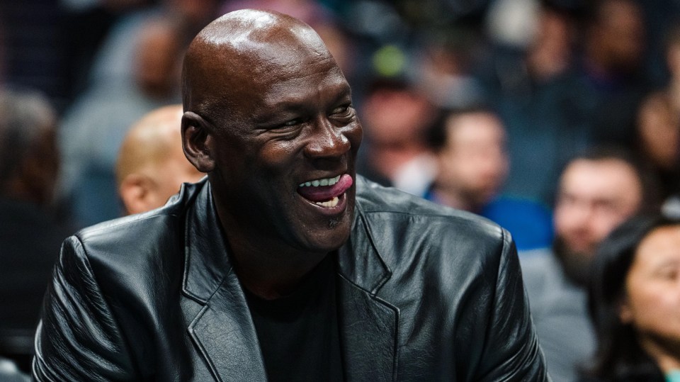 Michael Jordan sits at a Charlotte Hornets game