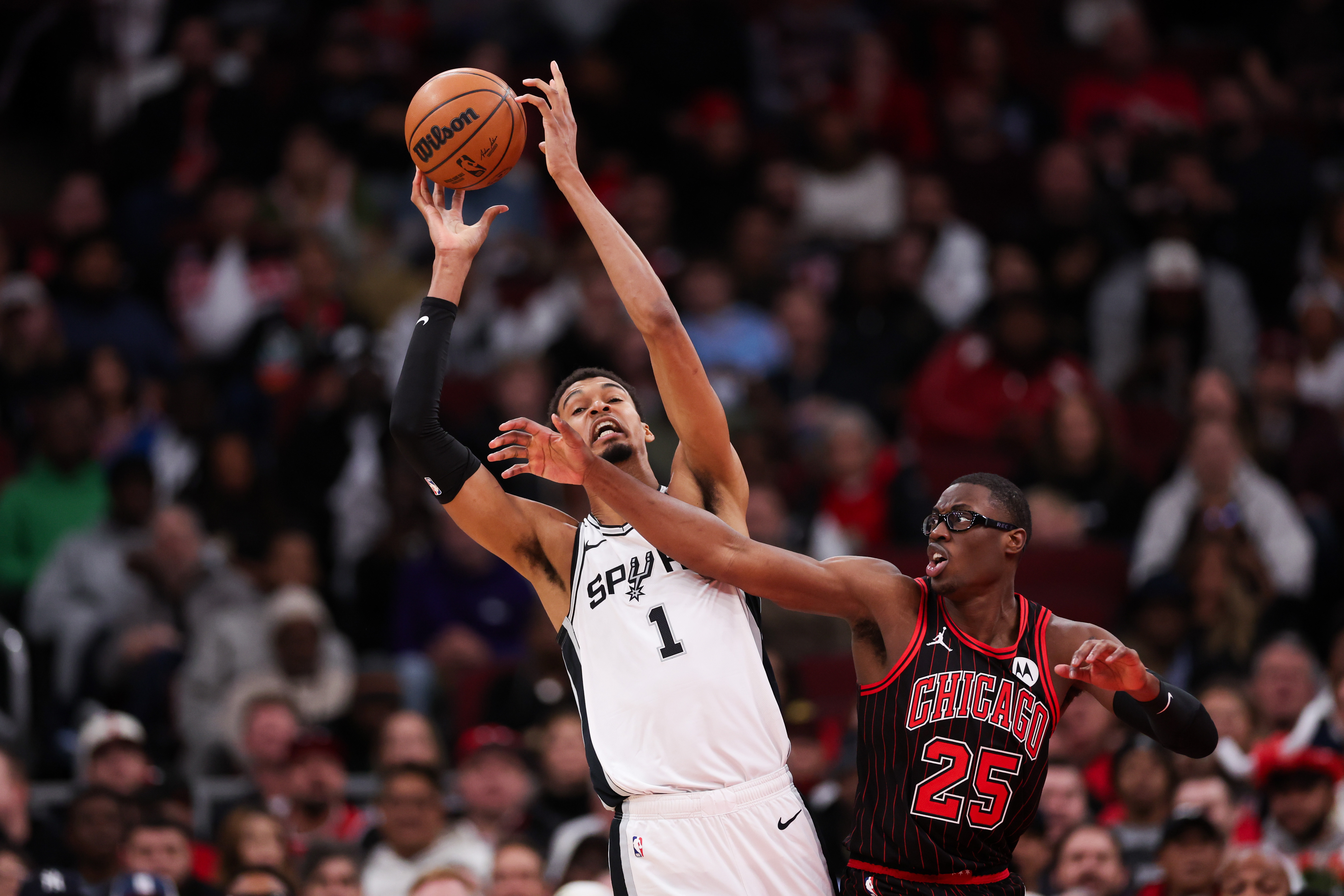 San Antonio Spurs forward Victor Wembanyama (1) grabs a rebound over Chicago Bulls forward Jalen Smith (25) during the second quarter at the United Center on Monday, Nov. 10, 2025, in Chicago. (Armando L. Sanchez/Chicago Tribune)