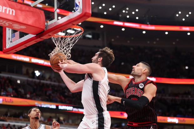 Chicago Bulls center Nikola Vučević (9) fouls San Antonio Spurs center Luke Kornet (7) during the fourth quarter at the United Center on Monday, Nov. 10, 2025, in Chicago. (Armando L. Sanchez/Chicago Tribune)
