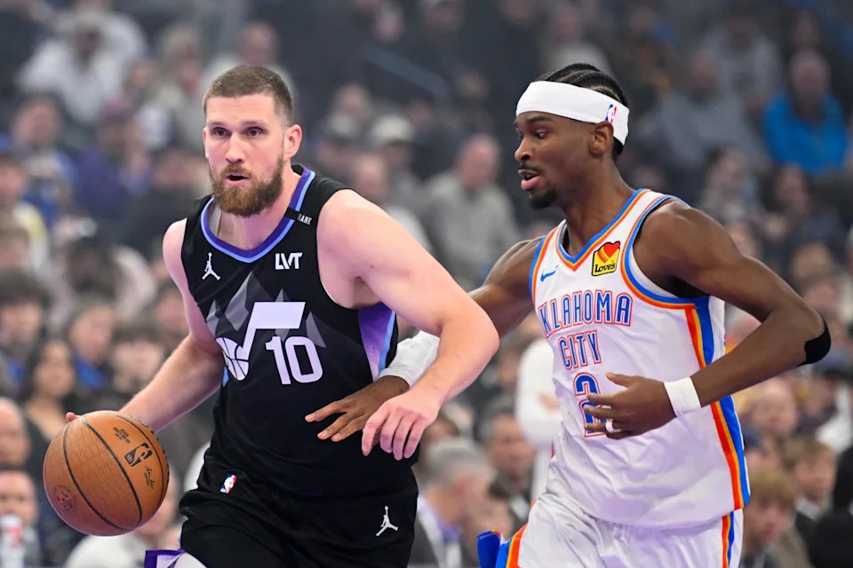 SALT LAKE CITY, UTAH - NOVEMBER 21: Svi Mykhailiuk #10 of the Utah Jazz drives past Shai Gilgeous-Alexander #2 of the Oklahoma City Thunder during the first half of a 2025-26 Emirates Cup game at Delta Center on November 21, 2025 in Salt Lake City, Utah. NOTE TO USER: User expressly acknowledges and agrees that, by downloading and or using this photograph, User is consenting to the terms and conditions of the Getty Images License Agreement. (Photo by Alex Goodlett/Getty Images)