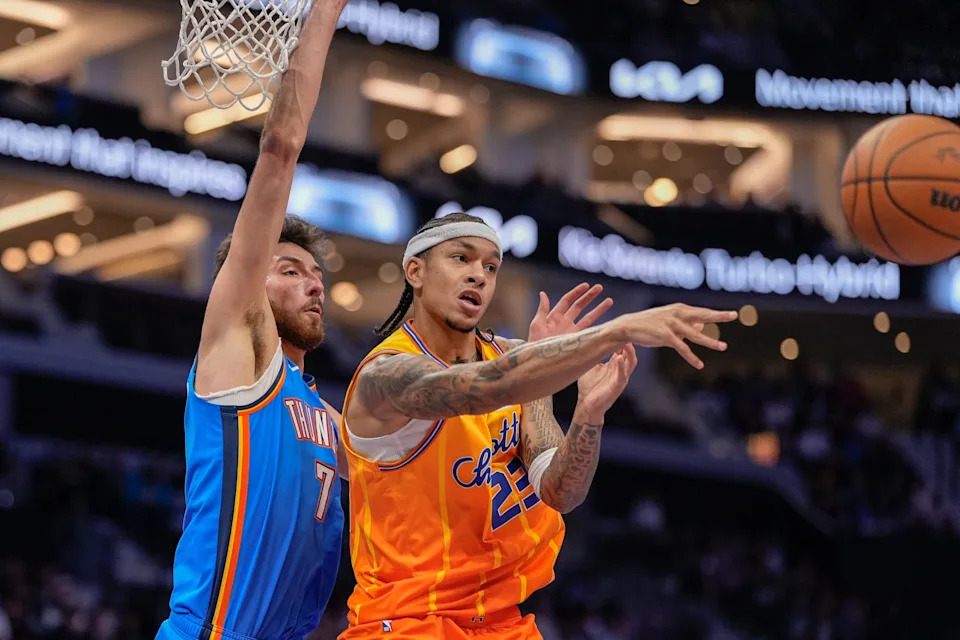 Nov 15, 2025; Charlotte, North Carolina, USA; Charlotte Hornets guard Tre Mann (23) passes the ball away from Oklahoma City Thunder center Chet Holmgren (7) during the first half at Spectrum Center. Mandatory Credit: Jim Dedmon-Imagn Images