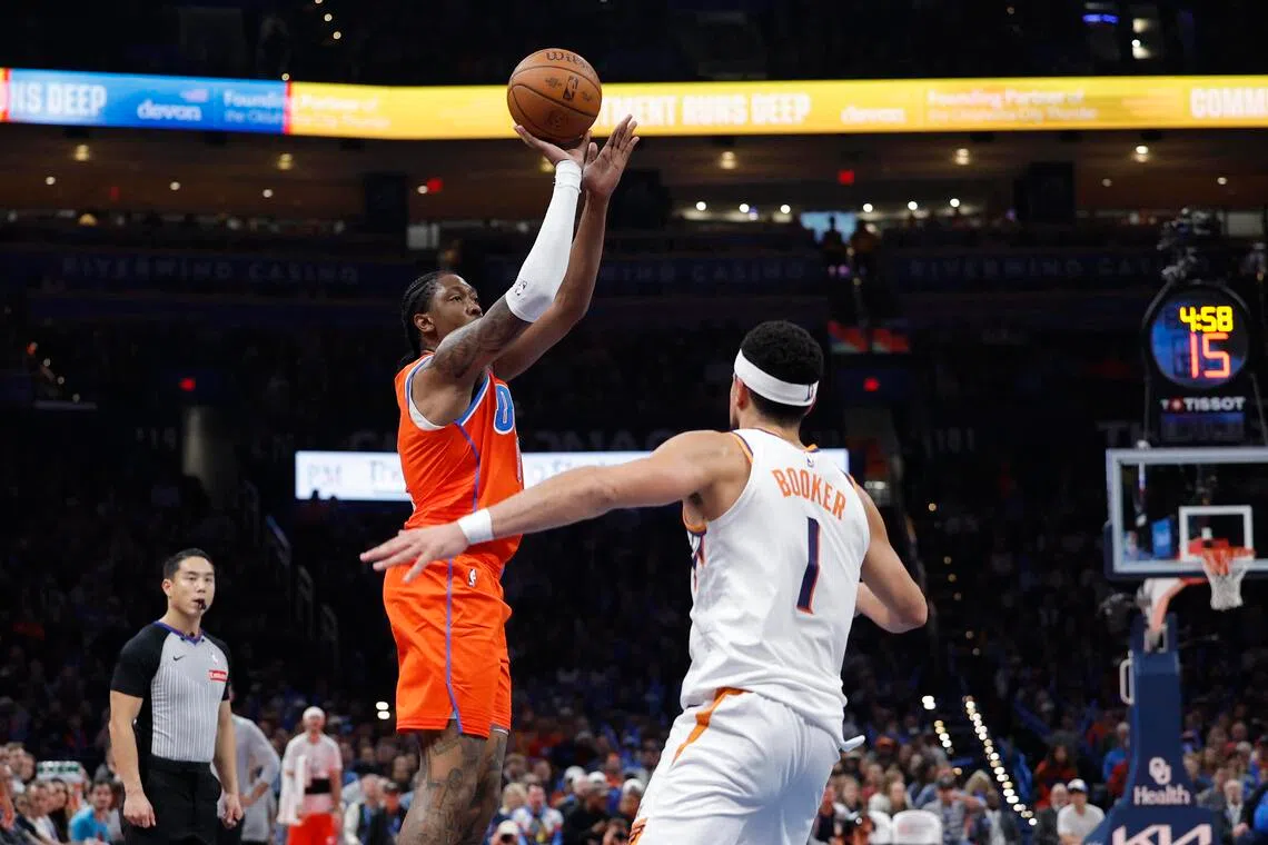 Oklahoma City Thunder guard Jalen Williams shooting over Phoenix Suns guard Devin Booker during the second half of the Thunder's 123-119 NBA win at Paycom Center on Nov 28, 2025. It was Williams' first game of the season after returning from two right wrist surgeries.