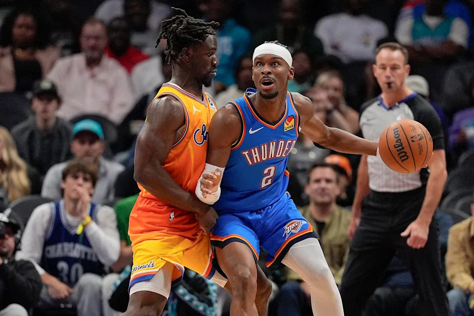 Nov 15, 2025; Charlotte, North Carolina, USA; Charlotte Hornets guard Sion James (4) defends against Oklahoma City Thunder guard Shai Gilgeous-Alexander (2) during the first half at Spectrum Center. Mandatory Credit: Jim Dedmon-Imagn Images