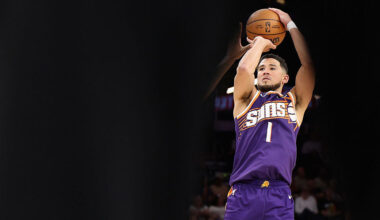 Devin Booker #1 of the Phoenix Suns attempts a shot against the Memphis Grizzlies during the fourth...