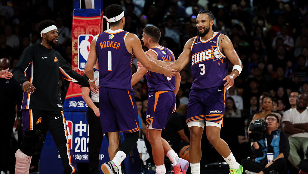 Dillon Brooks #3 of Phoenix Suns celebrates with Devin Booker #1 during NBA China Games 2025 betwee...
