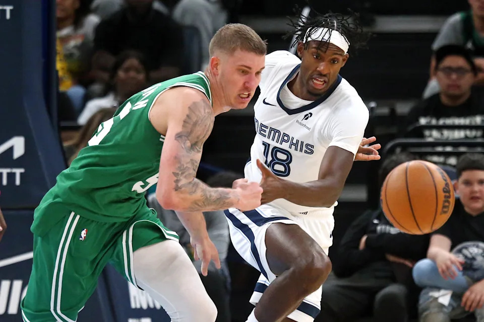 Oct 8, 2025; Memphis, Tennessee, USA; Boston Celtics forward Baylor Scheierman (55) and Memphis Grizzlies forward Olivier-Maxence Prosper (18) battle for a loose ball during the fourth quarter at FedExForum. Mandatory Credit: Petre Thomas-Imagn Images