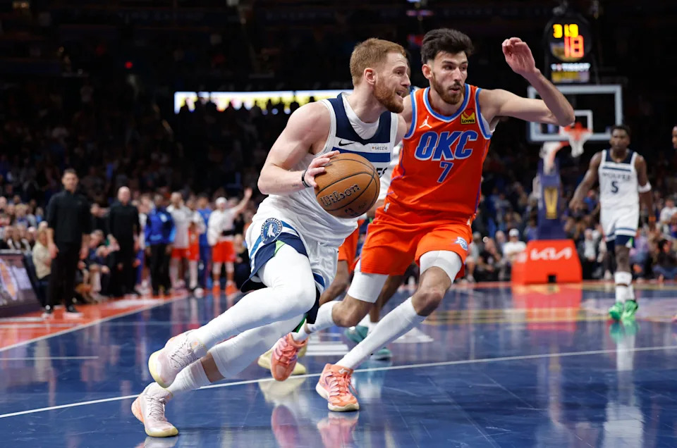 Nov 26, 2025; Oklahoma City, Oklahoma, USA; Minnesota Timberwolves guard Donte DiVincenzo (0) drives to the basket beside Oklahoma City Thunder center Chet Holmgren (7) during the second half at Paycom Center. Mandatory Credit: Alonzo Adams-Imagn Images