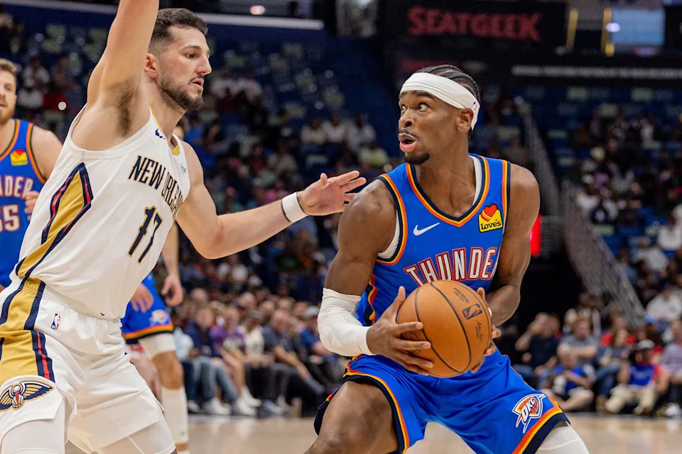 Nov 17, 2025; New Orleans, Louisiana, USA; during the first half at Smoothie King Center. Oklahoma City Thunder guard Shai Gilgeous-Alexander (2) dribbles against New Orleans Pelicans forward/center Karlo Matković (17) Mandatory Credit: Stephen Lew-Imagn Images