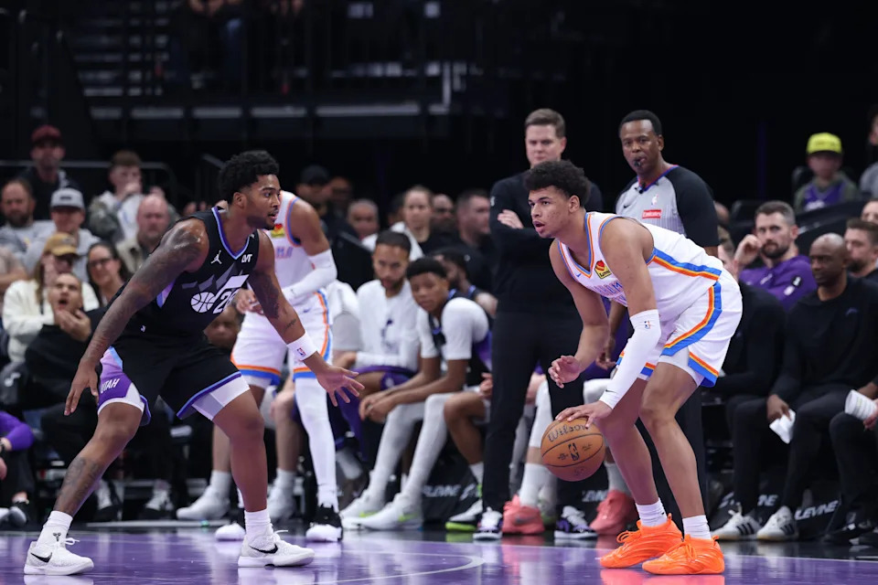 Nov 21, 2025; Salt Lake City, Utah, USA; Oklahoma City Thunder forward Ousmane Dieng (13) looks to pass as Utah Jazz forward Brice Sensabaugh (28) defends during the second half at Delta Center. Mandatory Credit: Rob Gray-Imagn Images